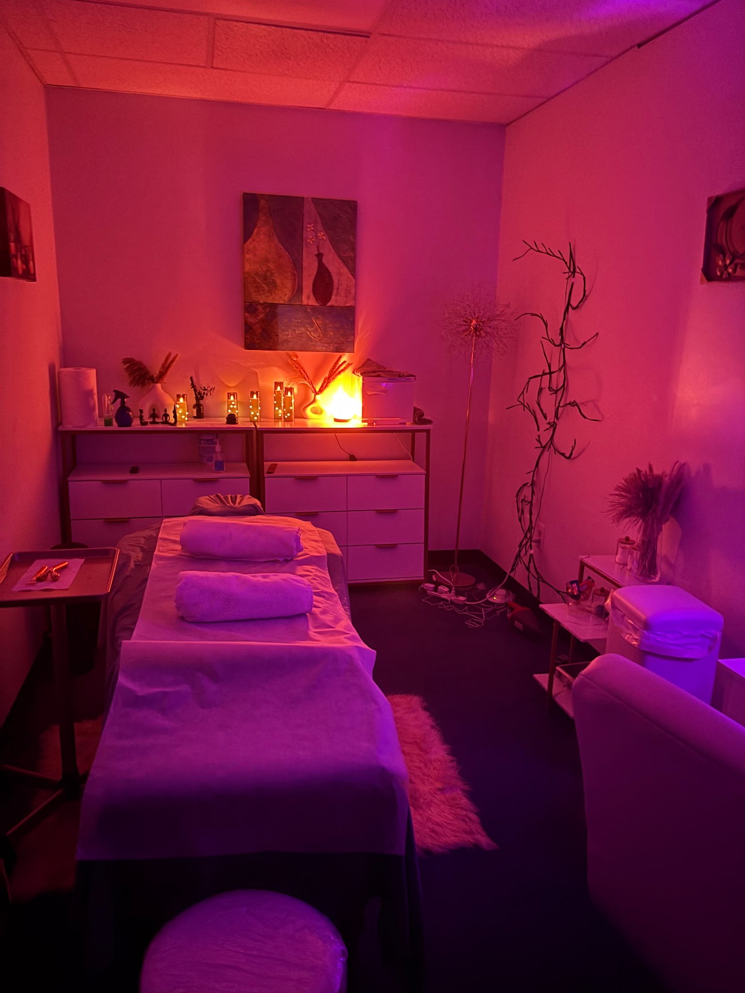 The Havens Room treatment room, warmly lit with candles